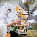 Workers in a food processing factory packaging food