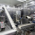 Automated production line in modern food factory. Ravioli production. People working.